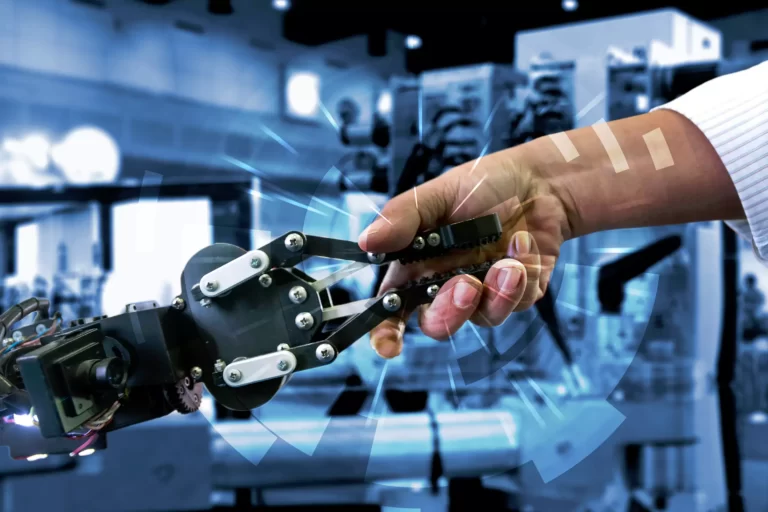 Man shaking a hand with a robotic arm