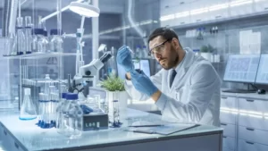 Life Sciences - Scientist amorously stares at a small baby plant, he feels fatherly